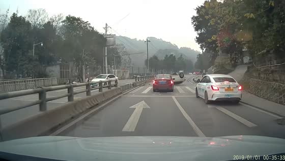 Car overturns near road barrier causing blockage in Chongqing, China