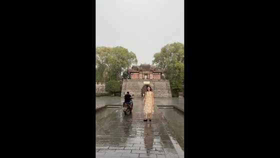 Motorcyclist slips on wet pavement at Guihu Park, China