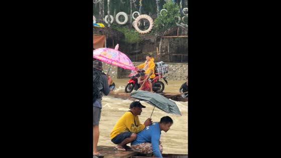 Filipinos exhibit 'BAYANIHAN' helping delivery rider cross Tinipak River in Tanay, Philippines