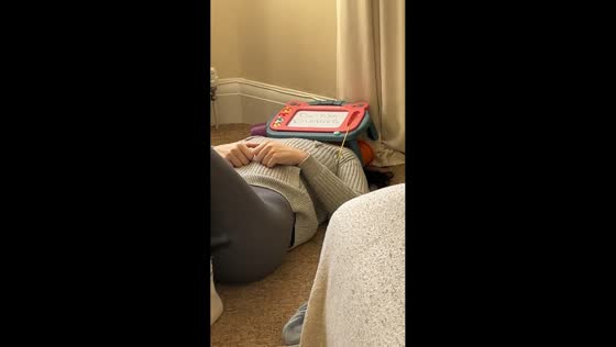 Mother rests with Do Not Disturb sign as grandparents entertain baby in Stoke-on-Trent, UK