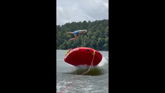 Two girls launched from tube during fast-paced lake ride in Kirby, Arkansas, USA