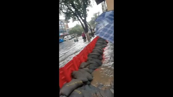 Sandbag barriers protect residential street from heavy flooding in Shandong, China