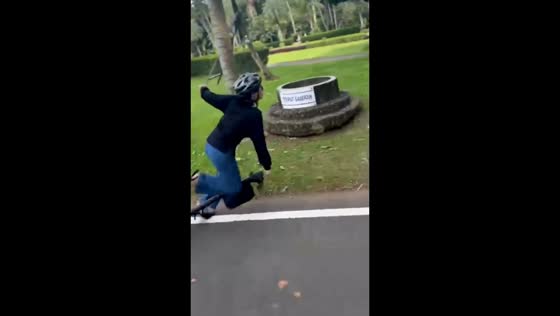 Woman loses balance and falls off electric scooter in Bogor, Indonesia