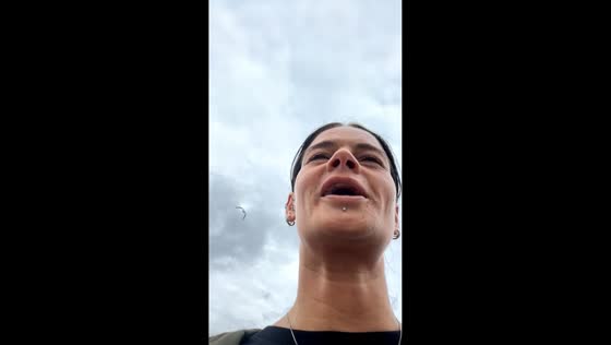 Woman ducks as seagull swoops overhead in Dumfries, Scotland, UK