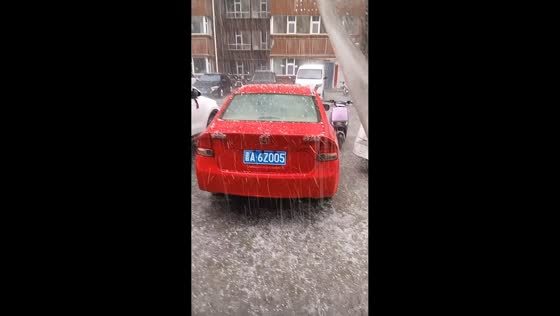 Severe hailstorm blankets parking area in Shanxi, China