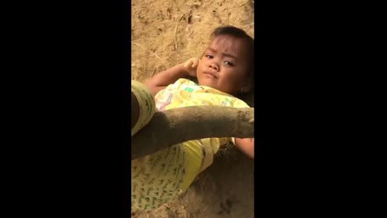 Tranquil resilience: girl calmly trapped in tree trunk
