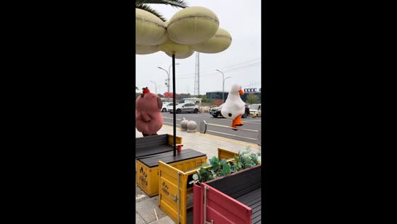 Mascots in duck and capybara costumes cross railing in playful scene in Jiangsu, China