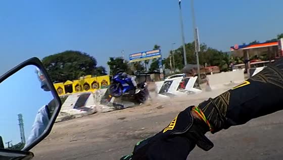 Motorbiker crashes into road barriers in Hyderabad, India