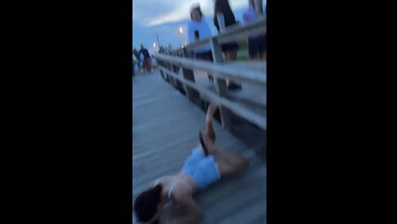 Woman falls off boardwalk railing behind officer in Avalon, New Jersey