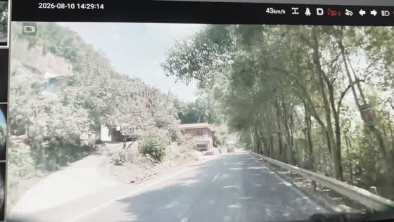 Detached truck tire rolls toward car on road in Sichuan, China