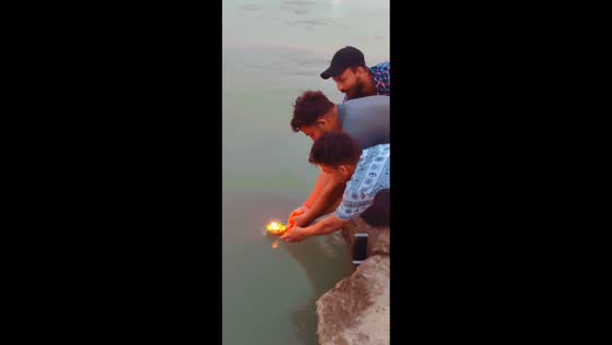 Man retrieves phone after it falls into lake in Rishikesh, India