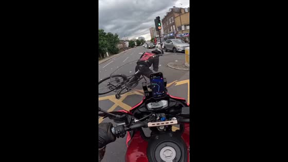 Cyclist nearly crashes into motorcycle at intersection in London, England, UK