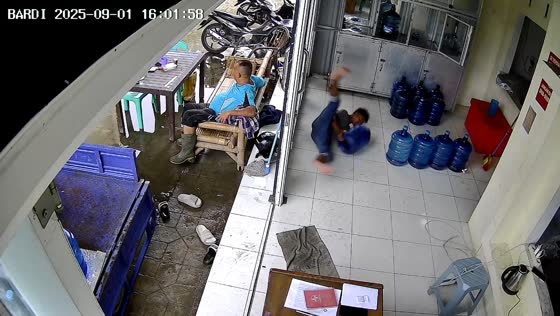 Worker slips carrying water container in Binjai, Indonesia