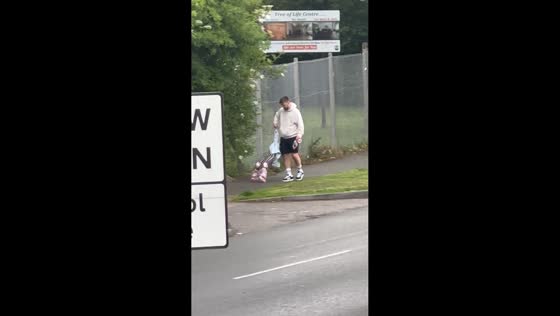 Little girl struggles on roller skates with patient help in Manchester, England, UK