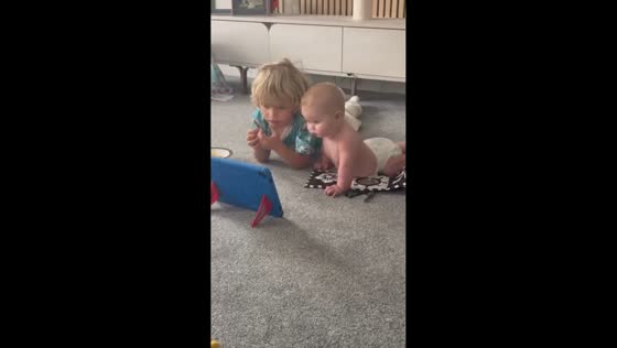 Brother playfully moves snacks away from baby sister in Wakefield, UK