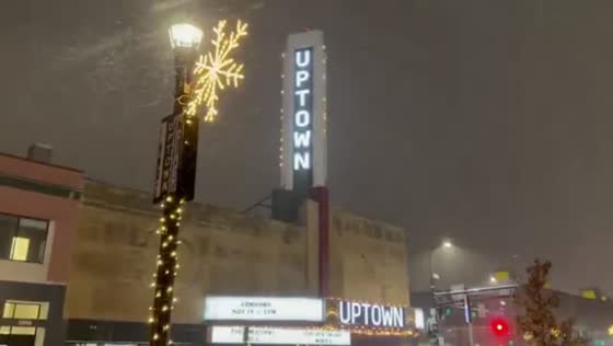Enchanting nighttime snowfall blankets city streets in Minneapolis, USA
