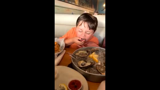 Boy reacts to tasting oyster in New Smyrna Beach, USA