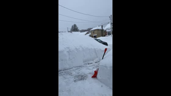 Man clears over six feet of snow after storm in Midland, Ontario, Canada