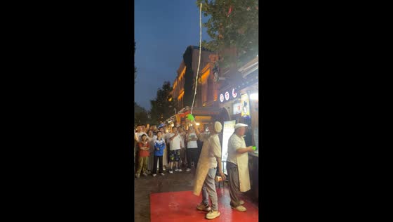 Street vendor performs Xinjiang-style shaved ice preparation in Kashgar, Xinjiang, China