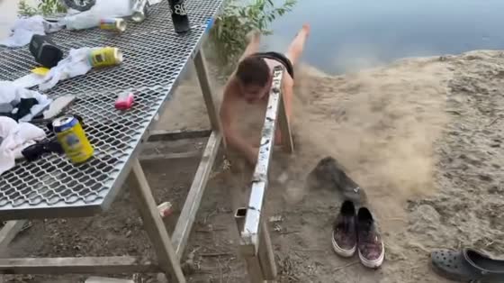 Man misses water landing and hits bench in rope swing mishap in in Laton, California, USA