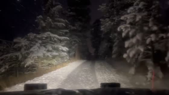 Snowplow navigates heavy winter roads in Evergreen, Colorado, USA