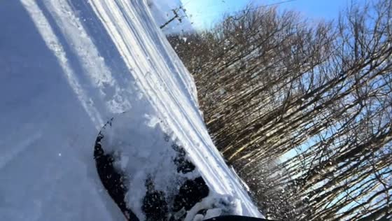 Man snowboards lying down on Monte Nerone in Marche, Italy