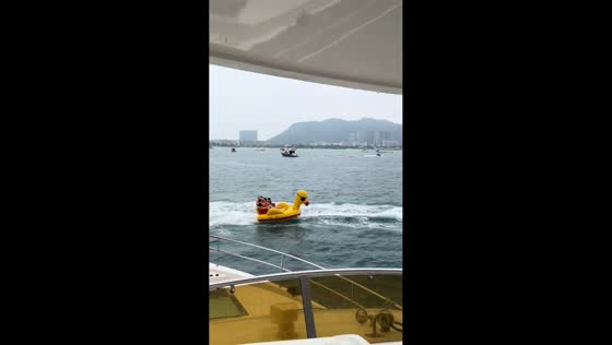 Riders fall from inflatable duck towable during water ride in Chongqing, China
