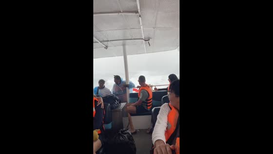 Tour boat braves stormy seas returning to port near Phuket, Thailand