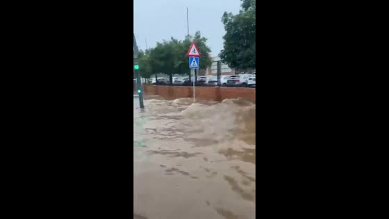 Bus struggles through deep floodwaters at Plaza de la Diversión in Seville, Spain
