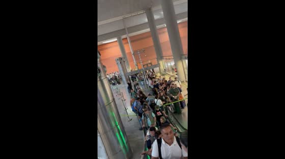 Crowded scene at Terminal 4 in Barajas Airport, Madrid, Spain