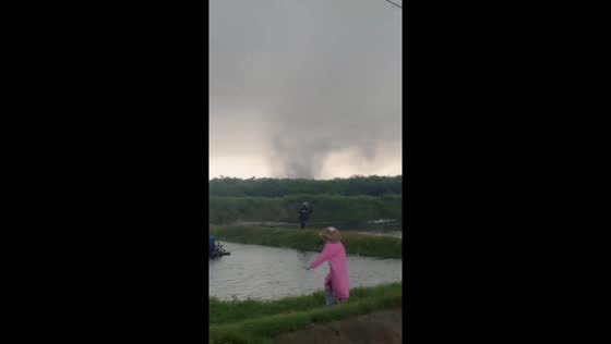 Tornado forms over a field as people flee in Hainan, China