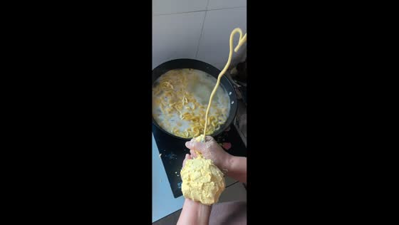 Cook demonstrates noodle-making skill using mini funnel in Liaoning, China