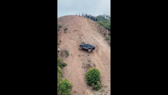 Off-road vehicle rolls down steep dirt wall during climb in Yunnan, China