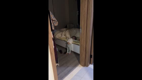 Girl falls asleep standing beside bed in Guangdong, China