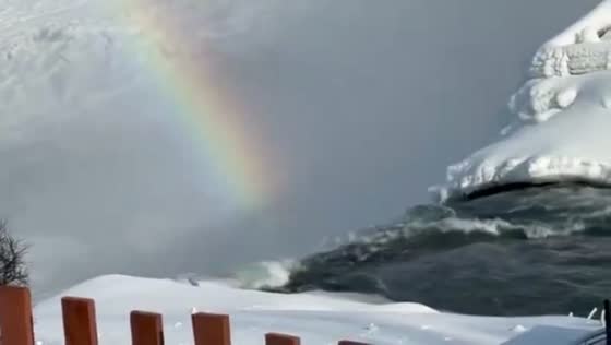 Rainbow shines amid icy winter weather in Niagara Falls, New York, USA