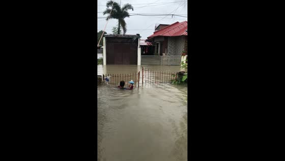Man wades through neck-deep flood during typhoon in Calumpit, Bulacan, Philippines