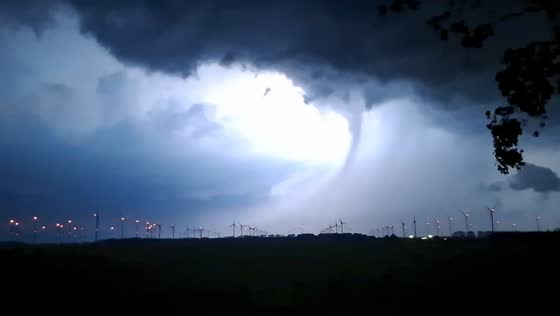 Lightning illuminates funnel cloud during severe storm in Woldendorp, Netherlands