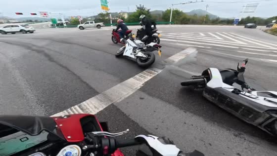 Sliding motorcycle rider collides with another motorcyclist at a traffic light in Gansu, China