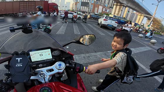 Student playfully twists motorcycle throttle at intersection in Guangdong, China