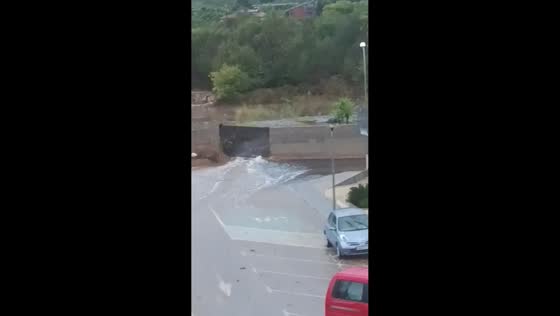 Torrential floodwaters burst through retaining wall in Alcanar, Spain