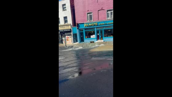 Burst water pipe sends floodwater surging across street in London, UK