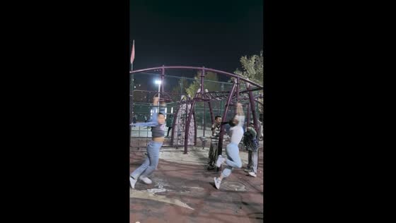 Girl spins rapidly on park equipment in Xinjiang