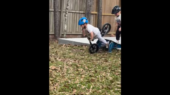 Brothers’ playful mishap on balance bike in Tulsa, Oklahoma, USA
