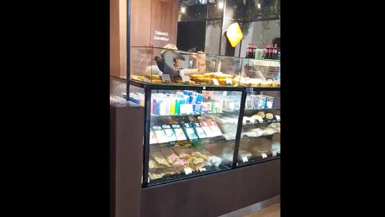 Bird spotted on store counter in Vilnius as person tries to remove it
