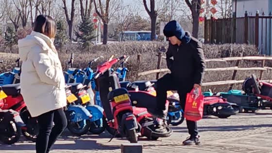 Man kicks parked electric motorcycles in Datong, Shanxi province