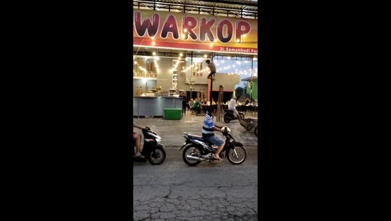 Motorcycle crashes into restaurant after avoiding tricycle in Binjai, Sumatra, Indonesia