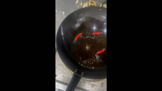 Chilies hilariously dance around a wok while frying in Yunnan, China