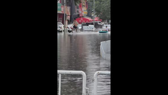 Man wakeboards through flooded street in Shenyang, China