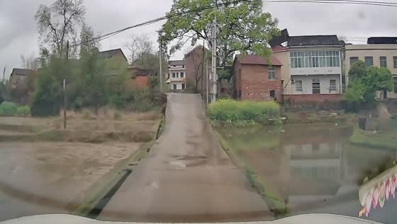 Driver navigates narrow road with water on both sides in Hunan, China
