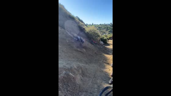 Mountain biker crashes into a hillside after launching off a dirt trail in San Diego, USA